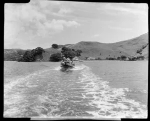 People on passenger boat, [Residence of Hodgson's family?, Oraukawa Bay? in the background], Bay of Islands, Northland