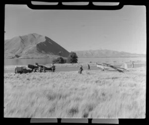 Unidentified group of people alongside aircrafts at Ohau airstrip, Mount Cook Southern Lakes, Southland