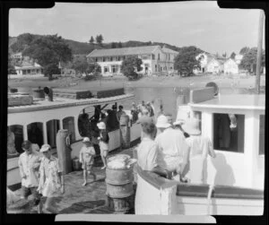 Russell Wharf, Bay of Islands, Northland, showing unidentified persons disembarking passenger boats [ferry?], with the Duke of Marlborough Hotel and Waterfront Tearooms in background