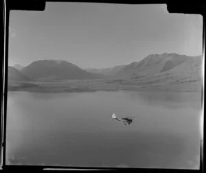 Mount Cook and Southern Lakes aircraft, Auster ZK-BOX in flight over Lake Ohau, Southland