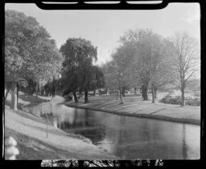 Christchurch Botanic Gardens, featuring the Avon River, a stone bridge and motor car's parked in the street