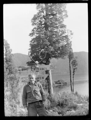 Gillespies Beach, South Westland, showing Jock Allen near sign saying Camp Entrance