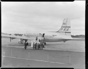 (PAA) Pan American World Airways DC4B aircraft at Whenuapai Airport, Auckland, showing passengers boarding