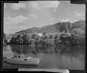 Waikato River, Ngaruawahia, including a boat moored in the foreground and a wooden bridge in the background