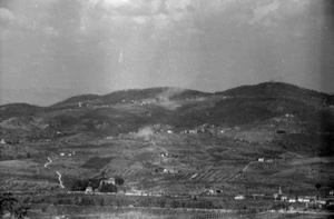 Enemy shells bursting on the village of San Michele during the advance of the New Zealand Division towards Florence