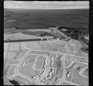 Murupara, Whakatane District, Bay of Plenty, showing newly developed housing subdivision and timber workers cabins beside State Highway 38, with pine plantation beyond