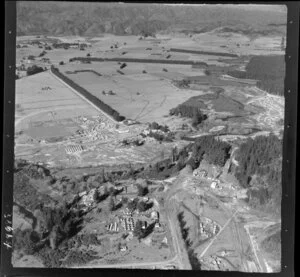 Murupara, Whakatane District, Bay of Plenty, showing newly developed timber mill contruction site with construction workers cabins, State Highway 38 and new subdivision under contruction beyond, open valley beyond