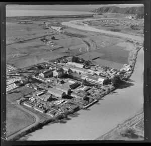 Whakatane Board Mills, Whakatane, Bay of Plenty, showing wood pulp processing plant besides Whakatane River, with view to coast with farmland and river mouth beyond