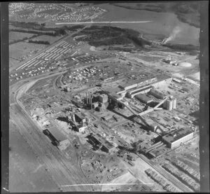 Kawerau, Bay of Plenty, showing southern end of the Tasman Pulp and Paper Mill under construction, with rail depot and housing development beyond