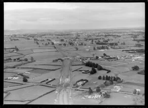 Papatoetoe, Auckland, showing Southern Motorway under construction through farmland with Auckland City beyond