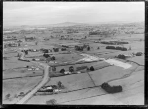 Papatoetoe, Auckland, showing Southern Motorway under construction through farmland with views to Rangitoto Island looking north