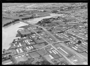 Showing Tamaki River with bridge and Southern Motorway under construction through residential area looking south with Princess Street East and Frank Grey Place, Otahuhu, Auckland