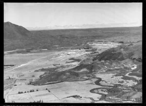 Kawerau, Bay of Plenty, showing Tasman Pulp and Paper Mill under construction within valley, with housing subdivision with Mt Edgecumbe and hills beyond