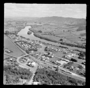 Taupiri, Waikato, view of township on the banks of the Waikato River looking south, Great South Road (State Highway 1) and railway station with Te Puru Street and Greenlane Road and Te Putu Street, with farmland beyond