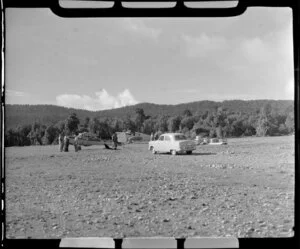 Fox Glacier airstrip, showing two aeroplanes and car on grass area