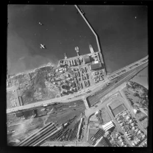 Auckland City, view over Quay Street and Tamaki Drive Motorway with Mechanics Bay and wharf area, railway yard, The Strand and bridge, Balfour Road with residential and commercial buildings, Dove Meyer Robinson Park, float plane on harbour