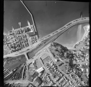 Auckland City, view over Quay Street and Tamaki Drive Motorway with Mechanics Bay and wharf area, railway yard, The Strand and bridge, Balfour Road with residential and commercial buildings, Dove Meyer Robinson Park