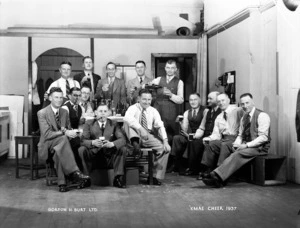 A group of men gathered for Christmas drinks at the rooms of Gordon Burt, photographer