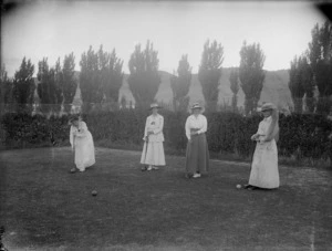 Women playing croquet