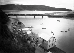 View of part of Paremata, including the boat sheds and the railway bridge
