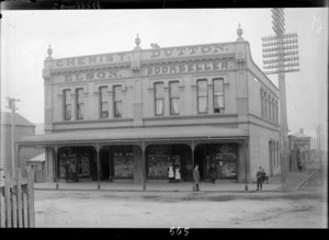 Business premises of Elson chemist and Dutton bookshop, Courtenay Place, Wellington, with the Coal and Wood Yard of F Holm visible around the corner in Cambridge Terrace.