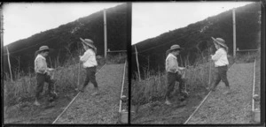 Brothers Edgar Richard (left) and Owen William Williams burying a dead cat in garden at the Williams' Royal Terrace house, Kew, Dunedin, Otago Region