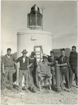 Men alongside a lighthouse on one of the Chickens Islands - Photograph taken for the Auckland Weekly News