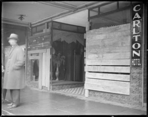 Shop windows boarded up as a result of a riot during the 1930s depression, Carlton Hotel, Lambton Quay, Wellington