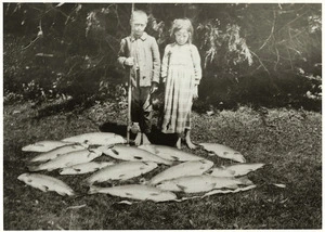 Maori children by a catch of trout