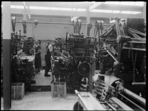 Workers weaving on machines in a wool factory