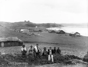 An unidentified group of children with a man in a bowler hat, at Kawhia Pa