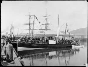 Saling ship Weka, moored at Wellington wharves,including passengers on deck and spectators alongside vessel