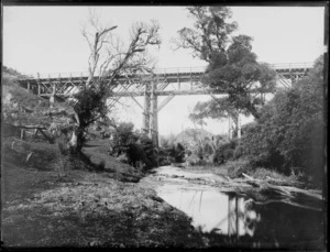 Railway viaduct, partly obscured by trees, location unidentified