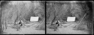 Unidentified man cooking at campsite on shore of lake [Te Anau?], Southland Region