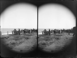 Military personnel (artillery) fire a cannon out to sea as spectators look on, Napier, Hawkes Bay Region