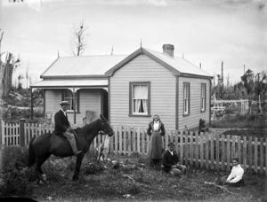 An unidentified family outside a Victorian colonial house, probably in the Stratford area