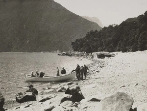 Group of men disembarking from a boat, Greenstone Gully, West Coast Region