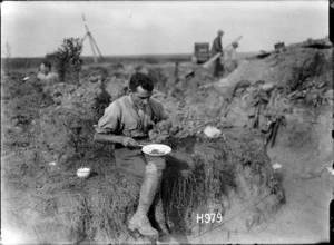 Sergeant Cyril Royston Guyton Bassett eating a meal in the trenches