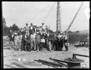 Group portrait of people involved with construction of Argo dredge together with women and children