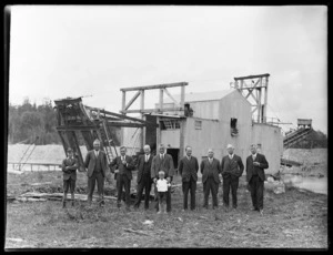 Group of directors with boy in front of the Argo dredge