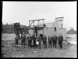 Group of directors and boy in front of the Argo dredge