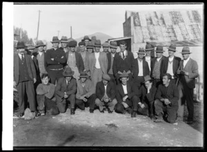 Group of miners on Top Road outside Co-op or Collins store