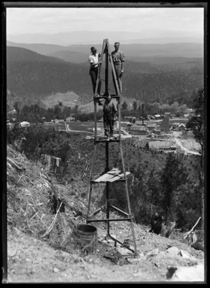 View over Waiuta with men standing on pylon under construction