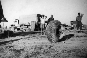 Soldiers of 1 NZ Amm Coy, at Bardia after Alamein, removing rims from a tyre of a 3 ton lorry.