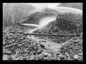 Sluicing gravels with high pressure water at Mount David sluicing claim