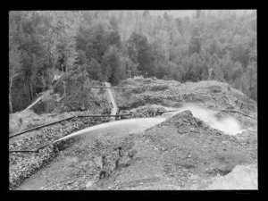 Sluicing claim with flume carrying gravels downhill in centre