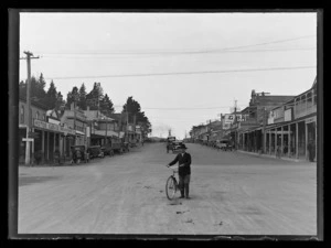 Joseph Divis with bicycle in the middle of Seddon Street, Waihi