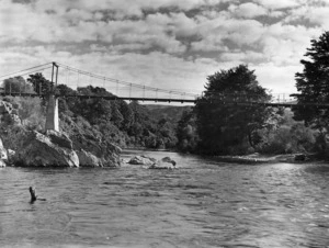 Upper reaches of the Hutt River, with the suspension bridge which crosses the river near the approach to the Mungaroa Hill