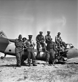 Members of the Maori Battalion in front of a German Messerschmitt fighter plane in Tripoli