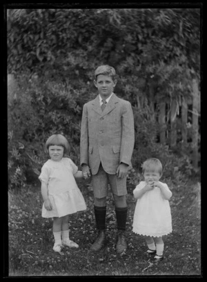 Portrait of boy with two small girls